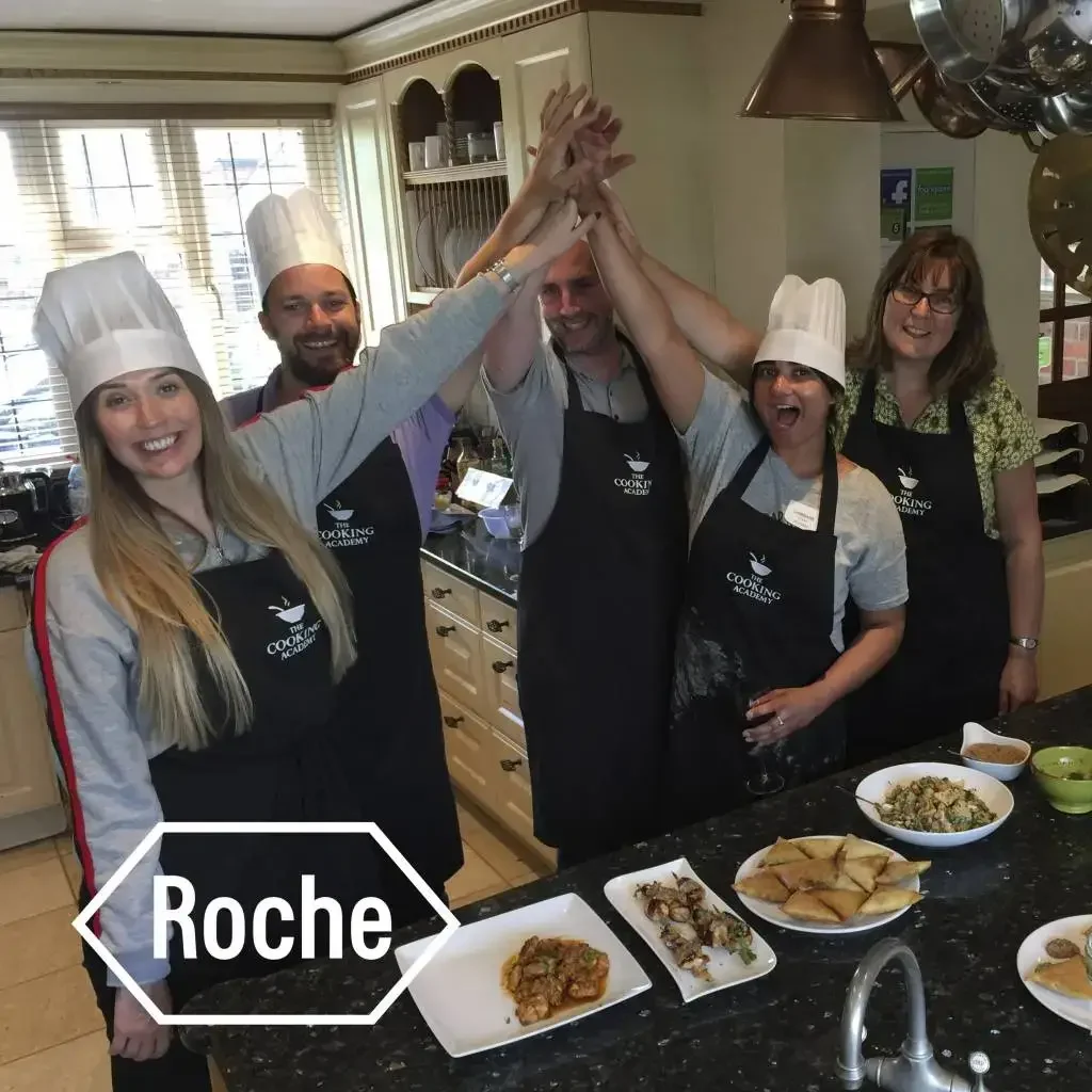 employees of roche company are attending corporate social responsibility events at 'The Cooking Academy'
